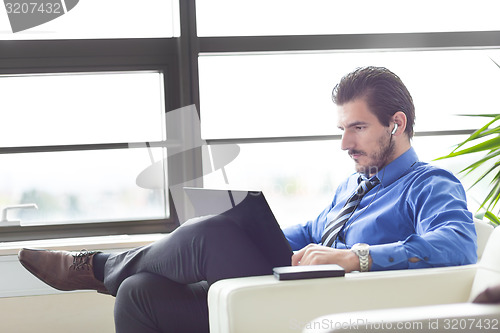 Image of Businessman in office working on his laptop. 
