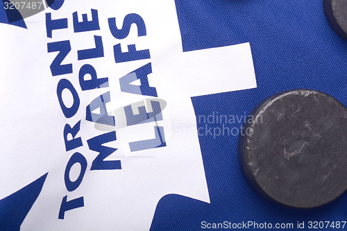 Image of KHARKOV UKRAINE JANUARY 22: Toronto Maple Leafs jersey and old hockey puck