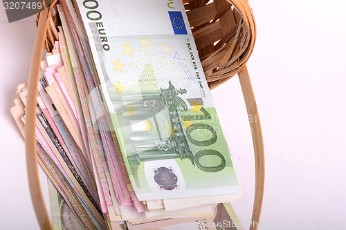 Image of european money on wooden basket, dollars, euro