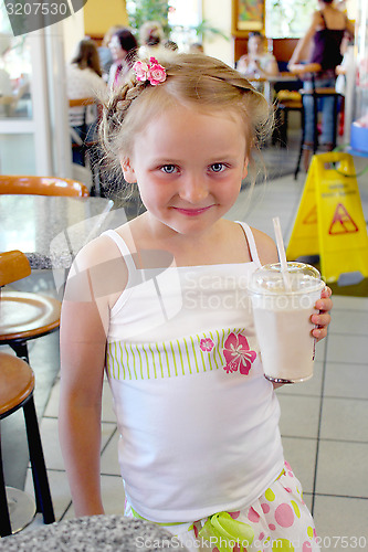 Image of beautiful girl having dinner in cafe