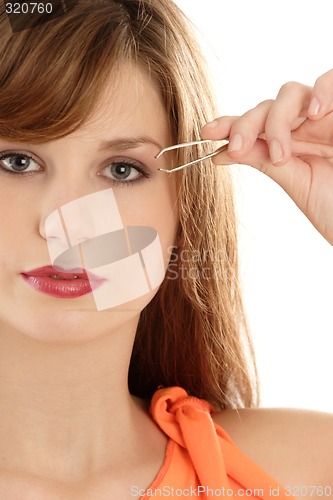 Image of Woman  plucking eyebrow
