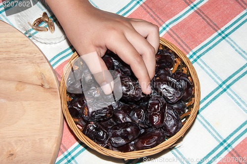 Image of Dates and the hand of the child