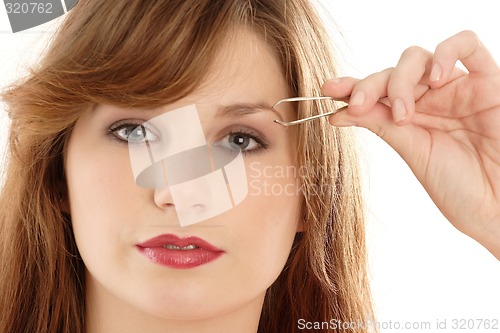 Image of Woman  plucking eyebrow