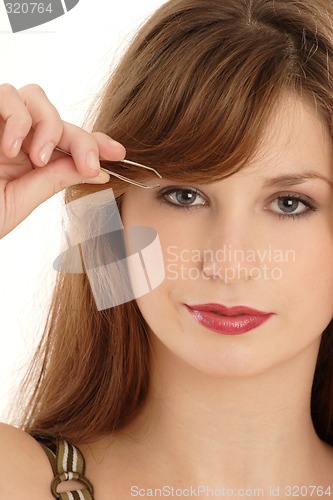 Image of Woman  plucking eyebrow