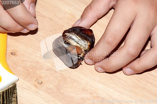 Image of Dates and the hand of the child