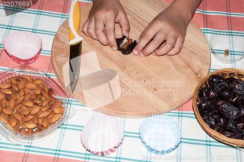 Image of Dates and the hand of the child