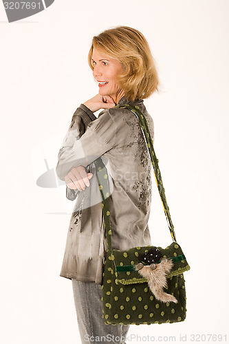 Image of Senior smiling lady with a designer handbag