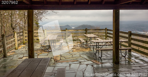 Image of picnic tables with mountain view background