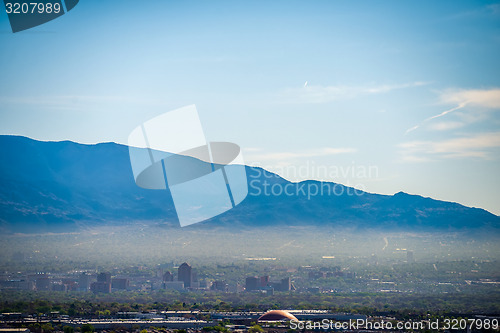 Image of  Albuquerque new mexico skyline in smog  with mountains