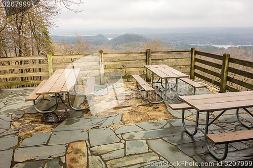 Image of picnic tables with mountain view background