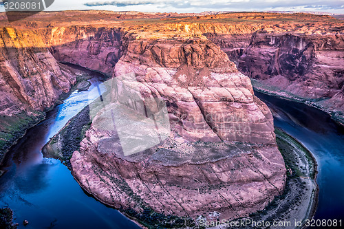 Image of horseshoe bend at sunrise with clear sky and colorado river belo