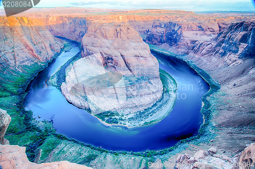 Image of horseshoe bend at sunrise with clear sky and colorado river belo