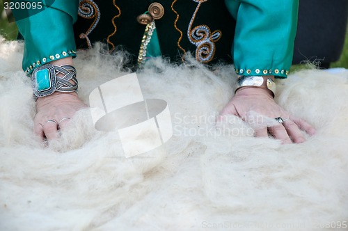 Image of Female Muslim hands works with wool