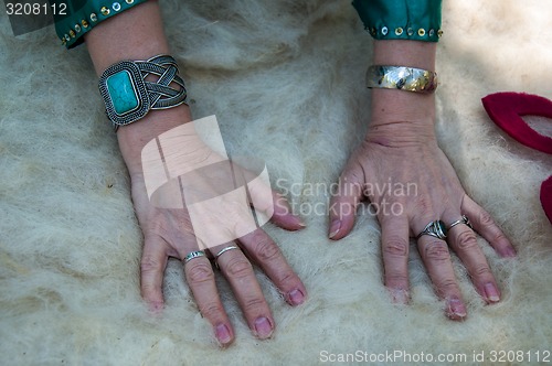 Image of Female Muslim hands works with wool