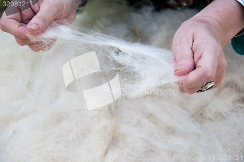 Image of Female Muslim hands works with wool