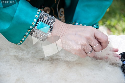 Image of Female Muslim hands works with wool