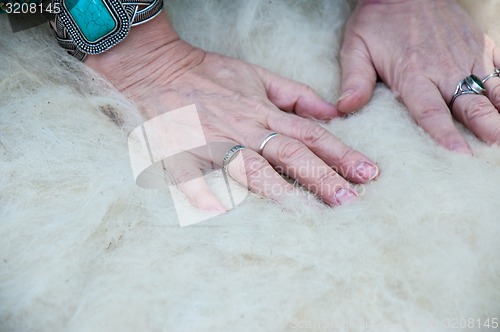 Image of Female Muslim hands works with wool