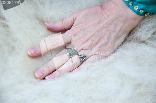 Image of Female Muslim hands works with wool