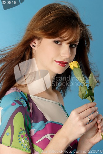 Image of Woman smelling rose