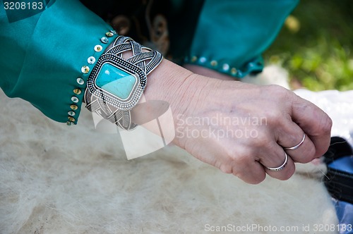 Image of Female Muslim hands works with wool