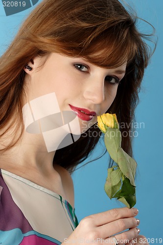 Image of Woman smelling rose