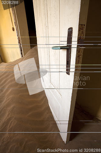 Image of door in sand