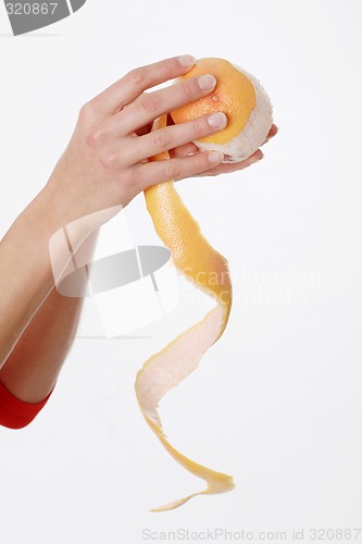 Image of Hands peeling orange