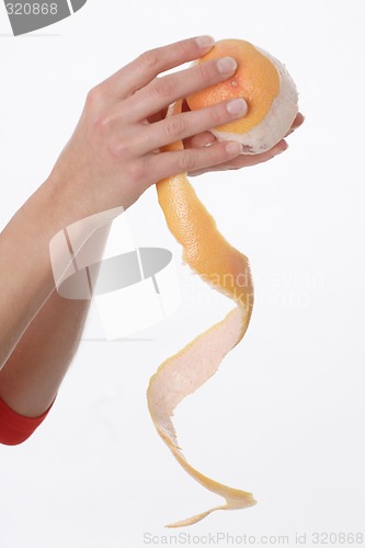 Image of Hands peeling orange