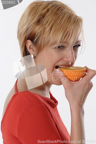 Image of Woman eating orange