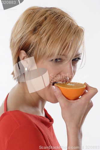 Image of Woman eating orange