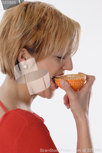 Image of Woman eating orange