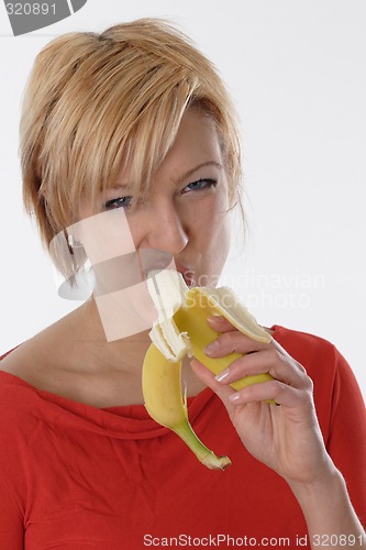 Image of Woman eating banana
