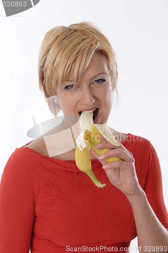 Image of Woman eating banana