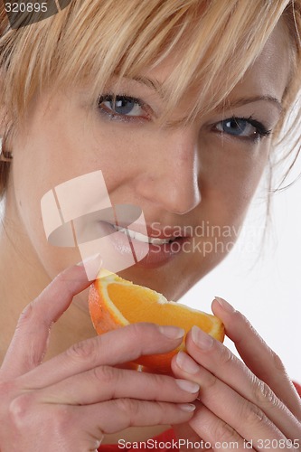 Image of Woman eating orange