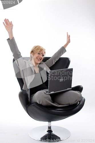 Image of Businesswoman jubilant with laptop