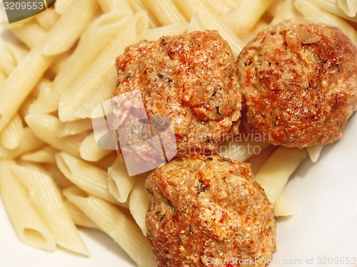 Image of Three meatballs with sauce over pasta