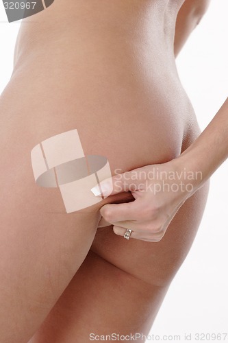 Image of Squeezing fat on hip