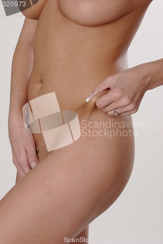 Image of Woman pinching waist