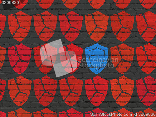 Image of Security concept: shield icon on wall background