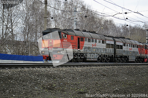 Image of The engine of gray color moves on railway tracks.