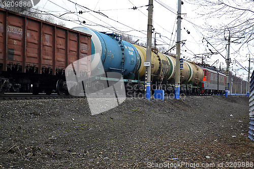 Image of The cargo train with tanks moves on railway tracks.