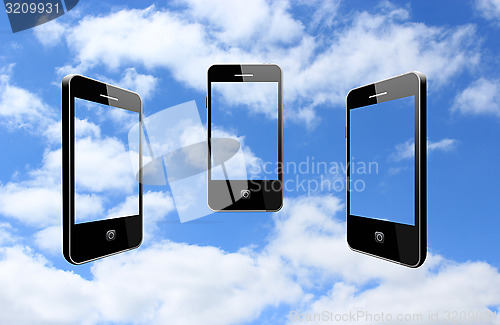 Image of three modern mobile phones on the sky