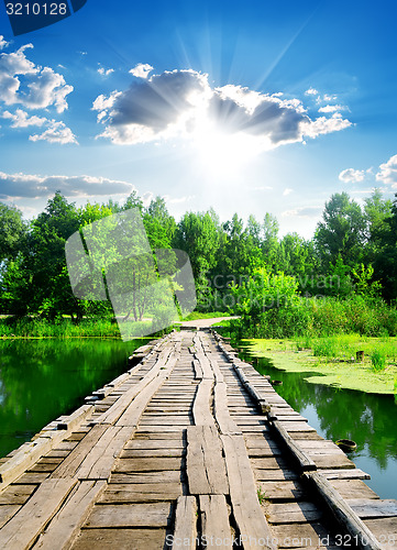 Image of Sun over wooden bridge