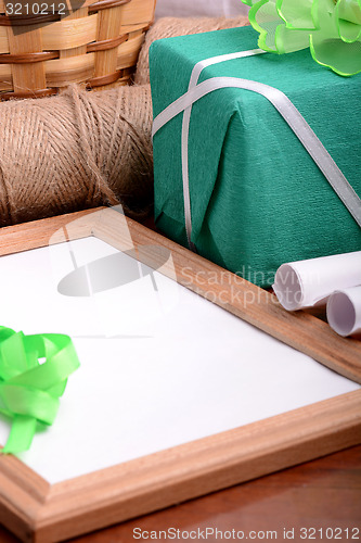 Image of green gift box and wooden board, holiday concept