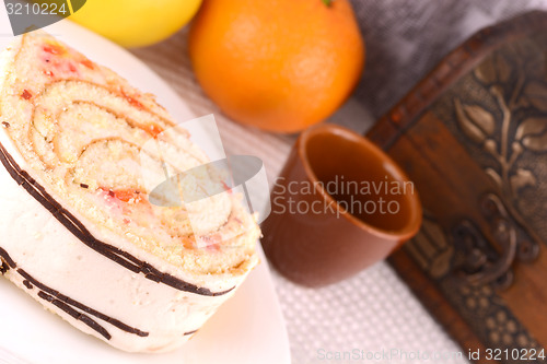 Image of sweet cake on white plate with fruits
