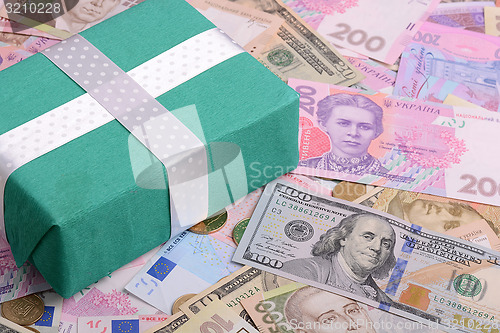 Image of american and european money background and green gift box