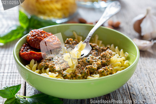 Image of Pasta with pesto with dried tomatoes, garlic and chili.