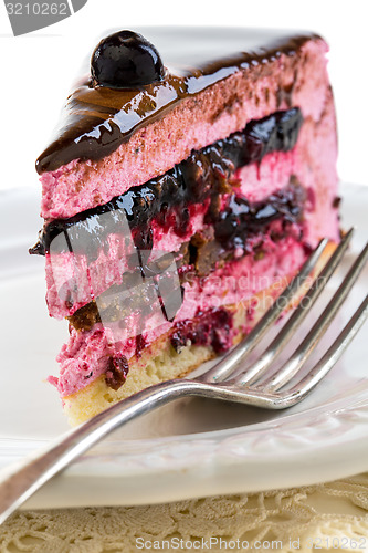 Image of Souffle cake with jelly berries and praline close up.