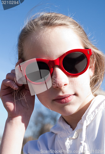 Image of young funny girl in sunglasses