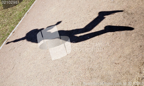 Image of human shadow in flying jump